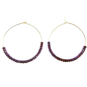 Gold hoop earrings with dark red beads